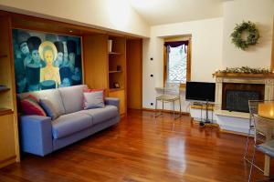 a living room with a couch and a fireplace at La Mansarda in Assisi