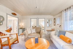 a living room with a couch and a table at Seaside Classic Cozy Bungalow in Seaside
