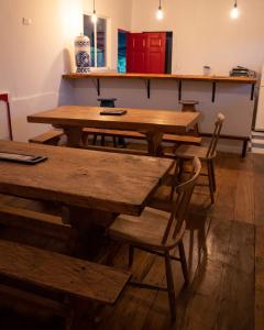 a group of wooden tables and chairs in a room at Birdglamping Los Arboles Hotel in Salento