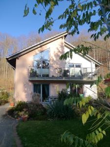 a house with a porch and a balcony at Ferienwohnung Am Wildmeisterweg in Wernigerode