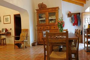 a dining room with a table and a wooden cabinet at Quinta Pero Vicente in Odeceixe +41 photos