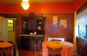 a dining room with a table and a cabinet at Hostal del Muelle in Valdivia +15 photos