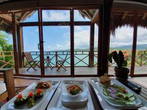 two trays of food on a table with a view at Hotel Boutique Siete Lunas in Sayulita
