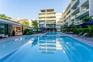 a swimming pool in front of a building at Oceana by ABNA in Playa del Carmen