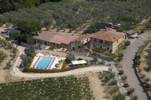 a house with a swimming pool and a tennis court at Agriturismo Amina, Winery & Hiking in Vagliagli