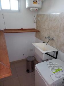 a small bathroom with a sink and a toilet at Family place in Luján