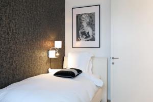 
A bed or beds in a room at Luxury Suite Koksijde 301 Adult only
