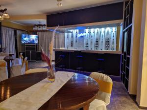 a dining room with a table with chairs and a television at Hotel Risco Plateado Room & Suite in Malargüe