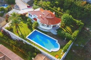 an aerial view of a house with a swimming pool at Villa Montgo Denia in Denia