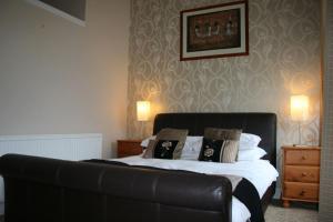 a bedroom with a bed with pillows on it at Royal Hotel in Girvan