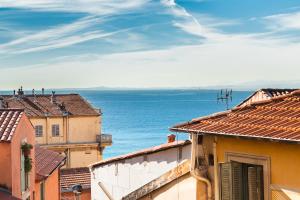 a view of the ocean from the roofs of buildings at Appartements Vieux Nice / Marché aux fleurs in Nice