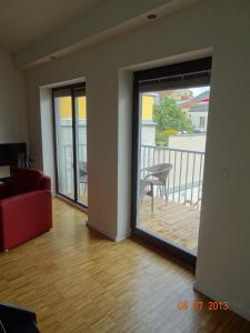 a living room with a door open to a balcony at Backbord Und Steuerbord in Stralsund