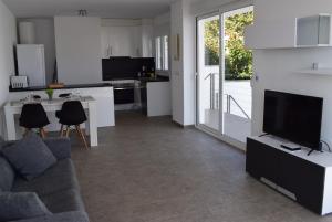 a living room with a couch and a tv and a kitchen at casa con piscina privada y cerca playa ref 382 in Empuriabrava
