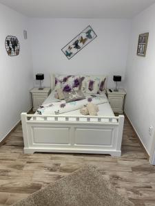 uma cama branca num quarto com duas mesas de cabeceira em Smiley Rezident em Sibiu