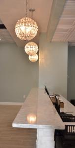 a table in an office with chandeliers at Opal Hotel & Suites in Orlando
