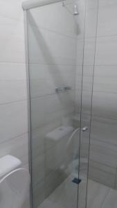 a glass shower in a bathroom with a toilet at Casa Joaninha centro in Canela +15 photos