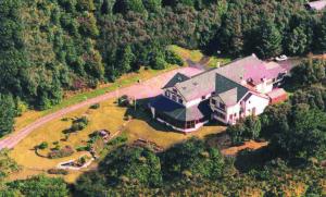 an aerial view of a large house in the forest at Gairloch Highland Lodge in Gairloch
