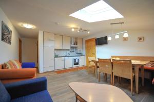 a living room with a kitchen and a dining room at Pension Grubhof in Stuhlfelden