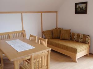 a living room with a couch and a table at Bio Bauernhof Vordergschwandtgut in Faistenau