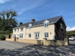 a large white house on the side of a street at The Croft Guest House in Narberth