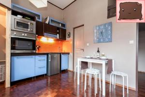 a kitchen with a counter and a table with stools at E47 Eötvös Apartment in Budapest