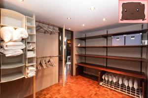 a room with a closet with shelves and towels at E47 Eötvös Apartment in Budapest