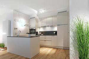 a kitchen with white cabinets and a counter top at Luxury Suite Koksijde 310 - Adults only in Koksijde