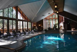 a swimming pool in a building with windows at Double Eagle Resort and Spa in June Lake
