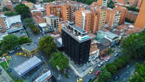 an overhead view of a city with a tall building at Factory Lofts Hotel in Medellín