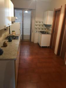 a kitchen with a wooden floor and a counter top at Villaggio Lamezia Golfo in Lamezia Terme