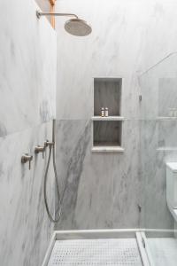 a bathroom with a shower with a glass door at Anafiotika hideaway acropolis Athens by Cycladica in Athens