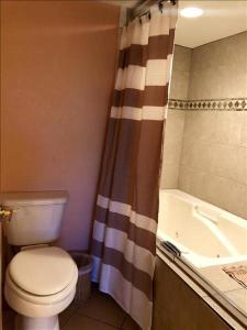 a bathroom with a toilet and a shower curtain at Saida IV Condos S4308 in South Padre Island