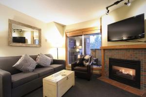 a living room with a couch and a fireplace at Glacier's Reach by Whistler Retreats in Whistler