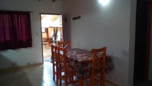 a dining room with a table and two chairs at LOS AROMOS in Mar de Ajó +41 photos