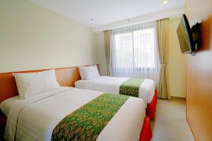 Postel nebo postele na pokoji v ubytování Savvoya Hotel Seminyak