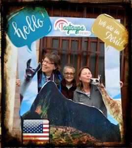 a group of three women standing in front of a sign at Taytaypa Rooms & Apartments Lima Airport in Lima