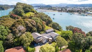 an aerial view of a house on a hill next to a river at Mooring Lane Lodge in Whitianga