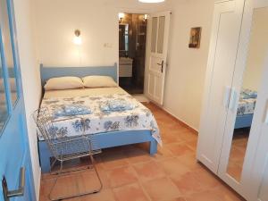 a small bedroom with a blue bed and a tiled floor at Boynuz Ağacı pansiyon in Kaleucagız