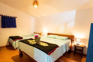 a bedroom with two beds with towels on them at Pochote Lodge in Hacienda Guayabo