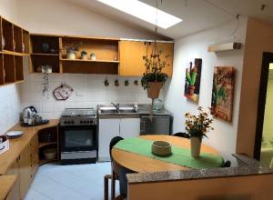 a kitchen with a wooden table in a kitchen at La mansarda di Orni in Ivrea +17 photos