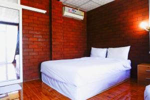 Ένα ή περισσότερα κρεβάτια σε δωμάτιο στο Pruksatara Garden