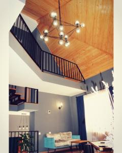 a living room with a staircase and a couch at Villa Kazbegi in Stepantsminda