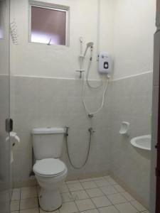a bathroom with a toilet and a shower in it at DK Guest Room in Kota Kinabalu