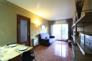 a living room with a table and a chair and a couch at Good-Apartments Barcelona in Barcelona