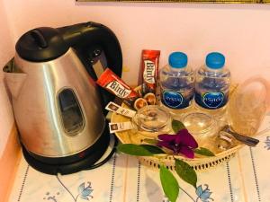 a tea kettle and bottles of water on a table at Rimsuan House in Ko Lanta