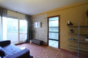 a living room with a couch and a large window at Good-Apartments Barcelona in Barcelona