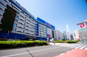 a city street with a large building on the side of the road at the b ikebukuro in Tokyo