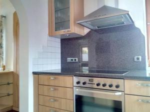 a kitchen with a stove and a microwave at Ferienhaus Rauris in Rauris