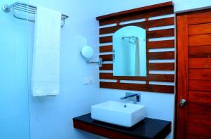 a bathroom with a white sink and a mirror at Happy Banana Hotel in Unawatuna +68 photos