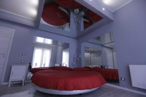 a bedroom with a large bed with red pillows at Cupido da Simona in Ostellato +38 photos